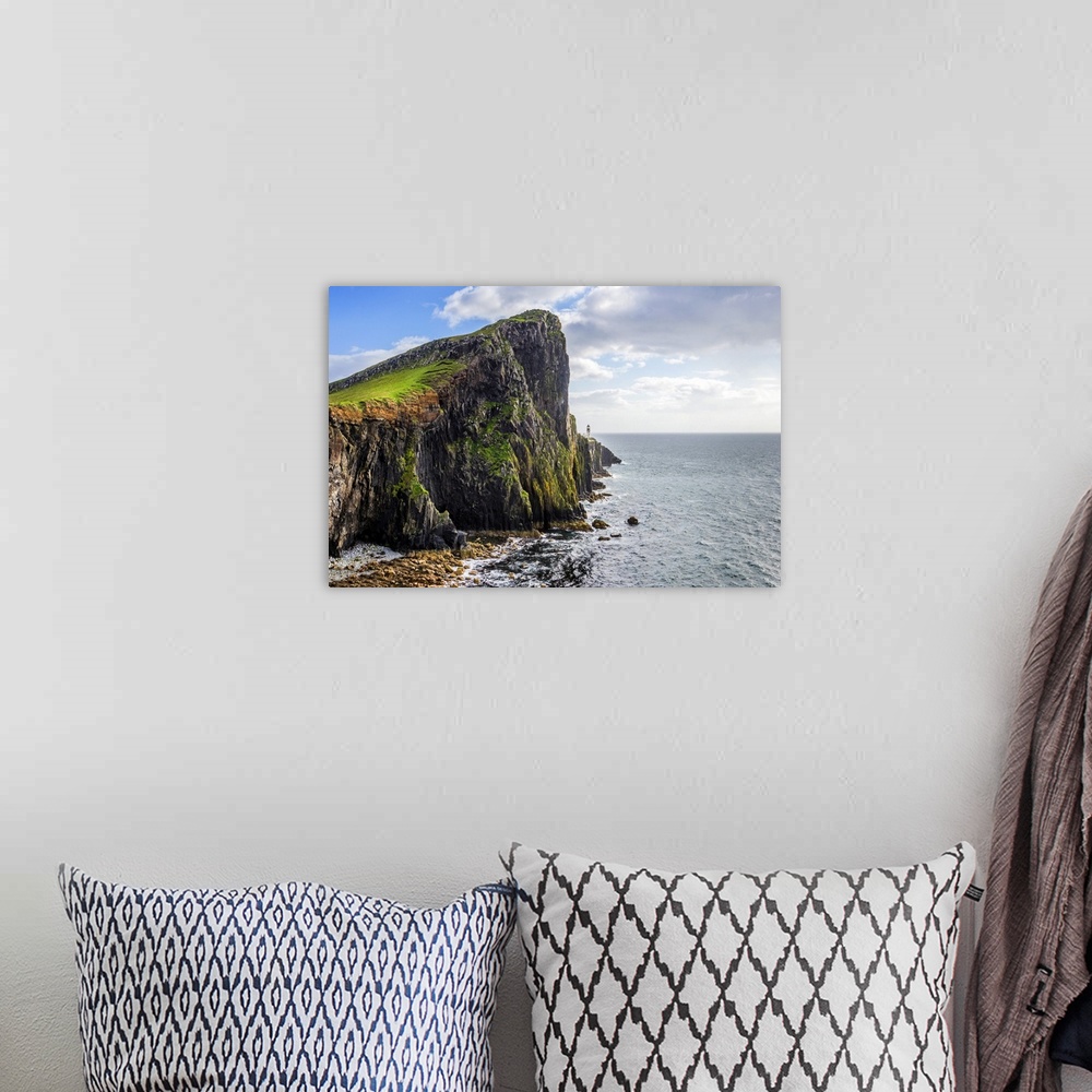 A bohemian room featuring Fine art photo of a rocky cliff overlooking the ocean.