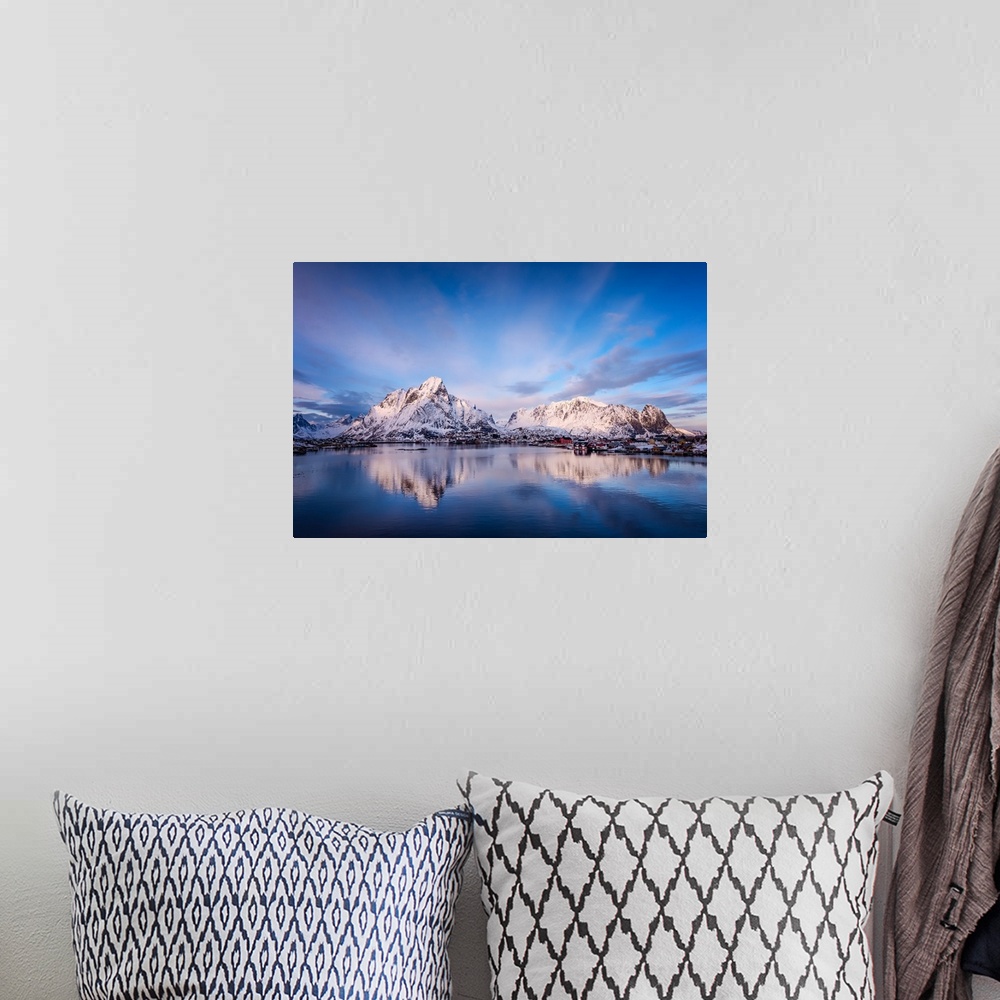 A bohemian room featuring A photograph of a mountain range seen from across a lake in winter.