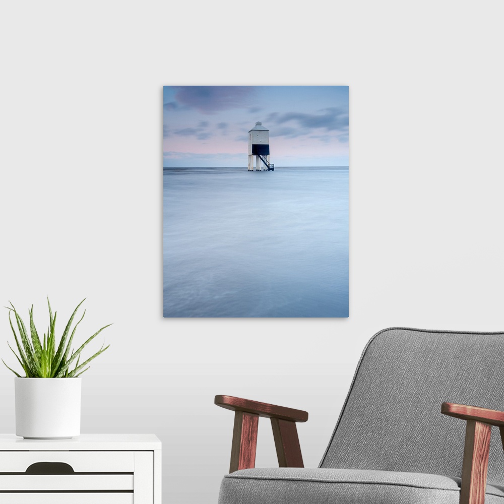 A modern room featuring A lighthouse stands guard on four strong legs in the ocean keep watch over the sea.