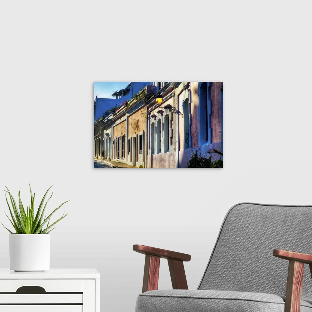 A modern room featuring A photograph of an old village, looking down a row of houses.