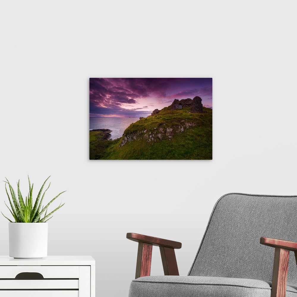 A modern room featuring Fine art photo of grassy hills overlooking the sea under a pastel sky at dusk.