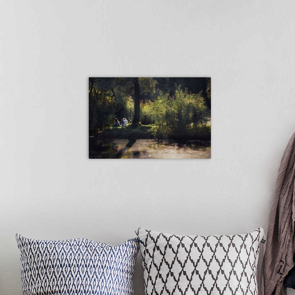 A bohemian room featuring A photograph of a couple sitting on a grassy clearing on a summer day.