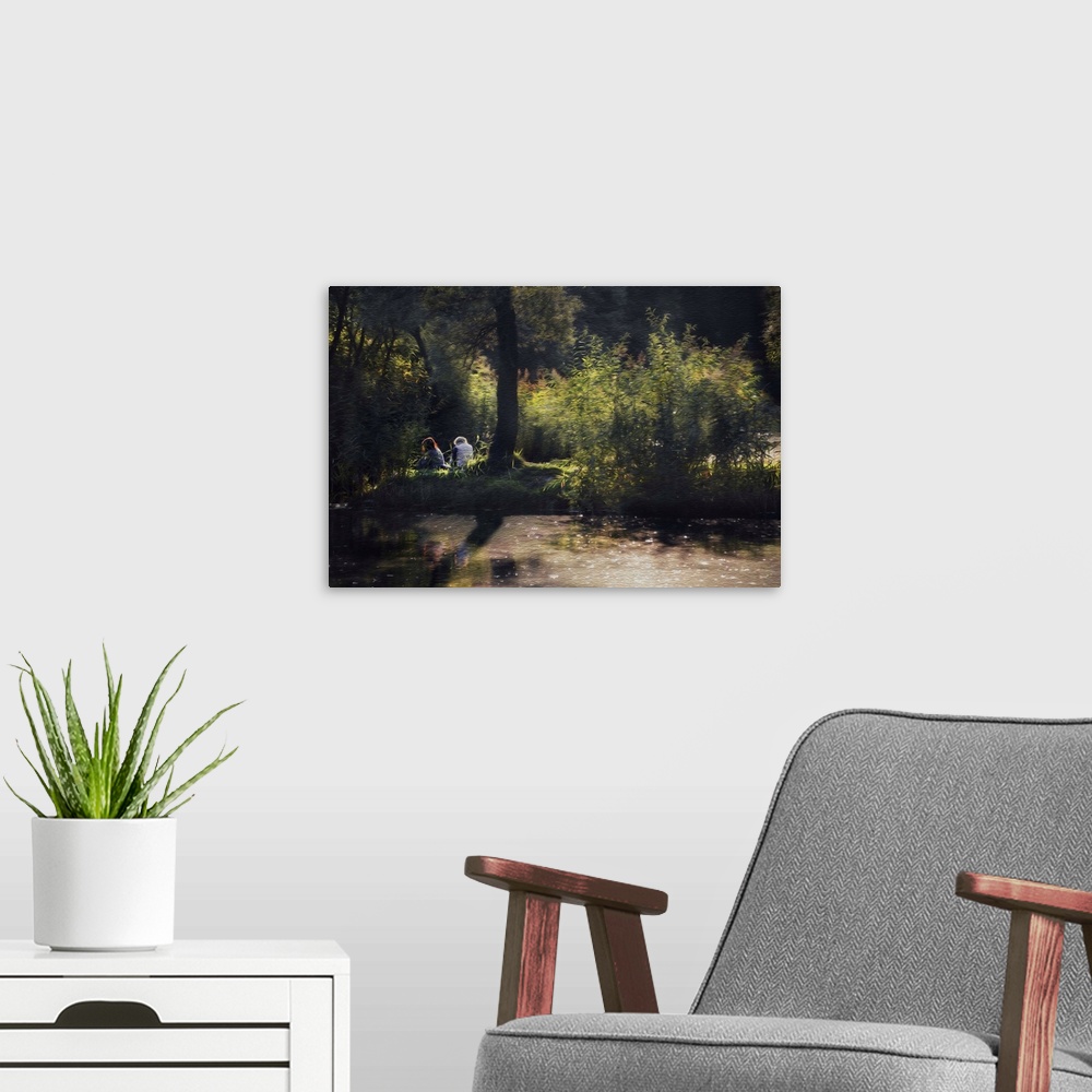 A modern room featuring A photograph of a couple sitting on a grassy clearing on a summer day.