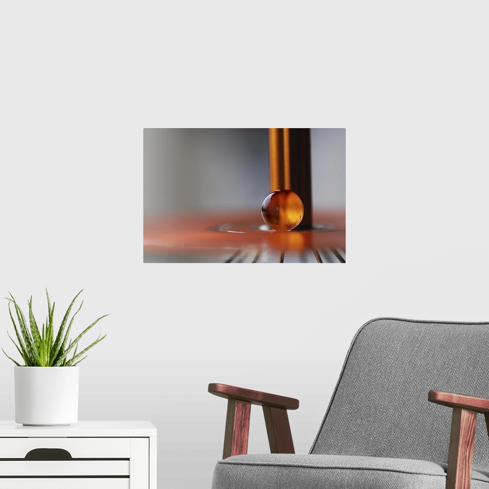 A modern room featuring A macro photograph of an orange water droplet against a abstract background.