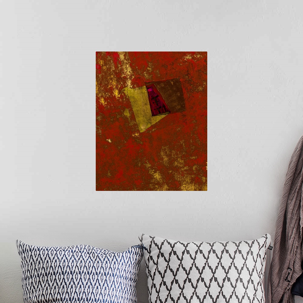 A bohemian room featuring An abstract expressionist image of shimmering textures and shapes in golds and crimson red.