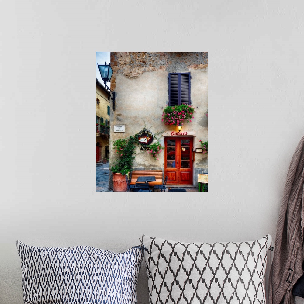 A bohemian room featuring A photograph of the outside of a restaurant in Italy.