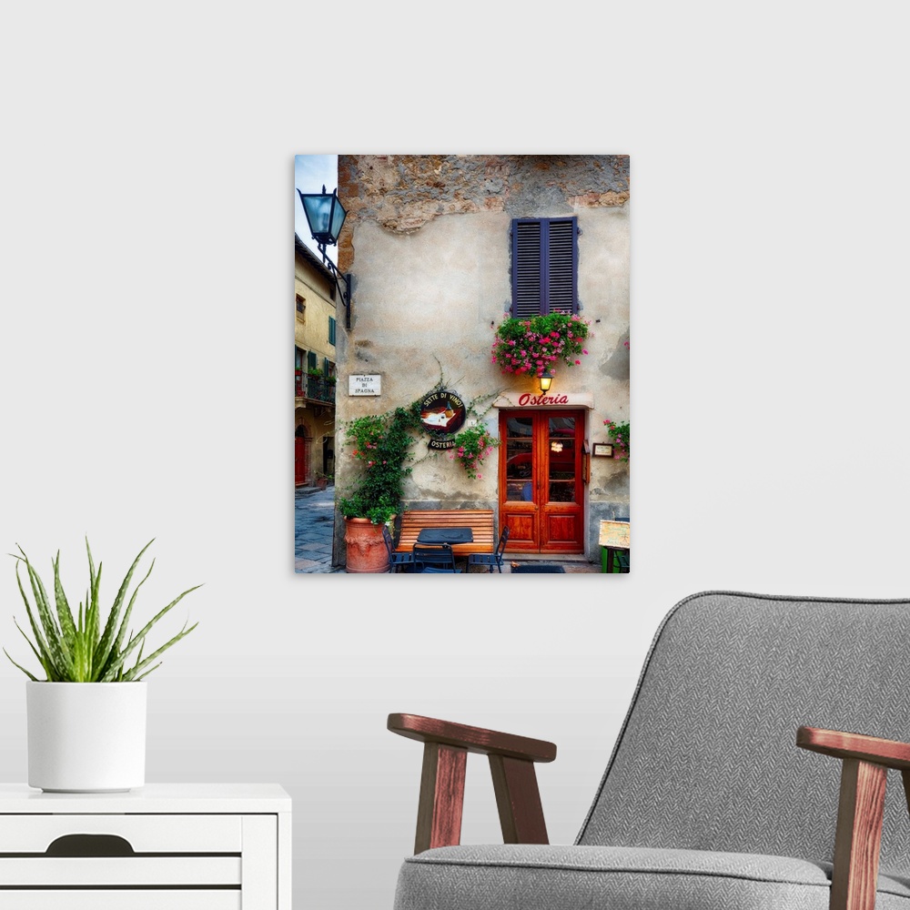 A modern room featuring A photograph of the outside of a restaurant in Italy.