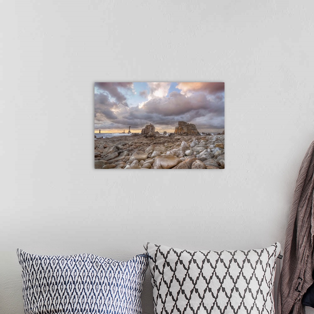 A bohemian room featuring Colored sunset at Pointe de Pern place in Ouessant island in France among rocks.