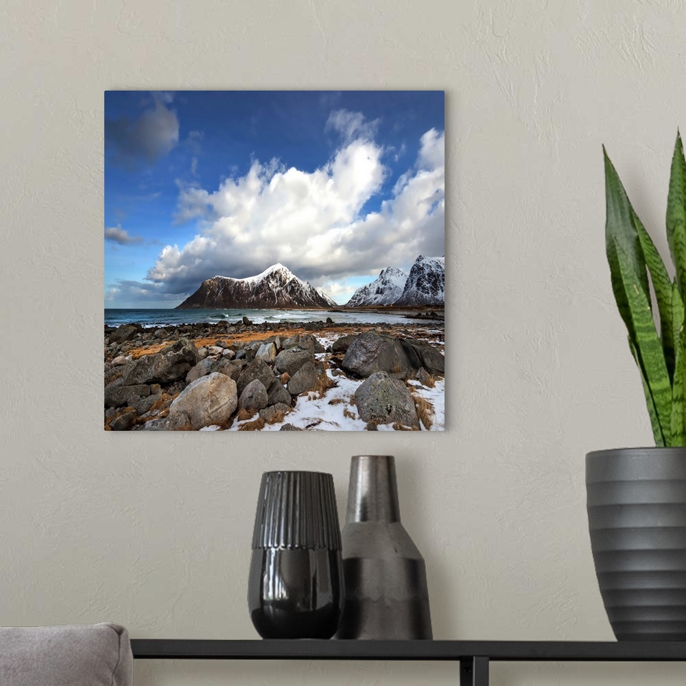 A modern room featuring Photograph of a mountain vista under a cloudy sky.