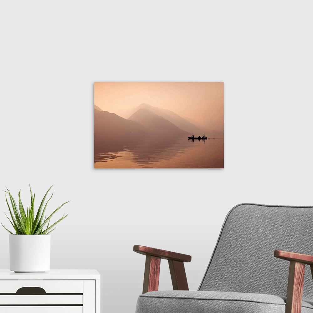 A modern room featuring A photograph of people in a rowboat on lake beside mountains in silhouette.