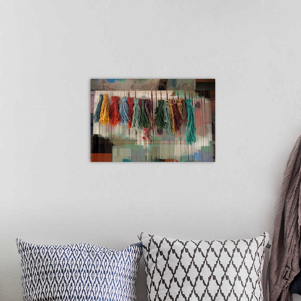 A bohemian room featuring Photograph of colorful bundles of yarn hanging on a line with an abstract background.