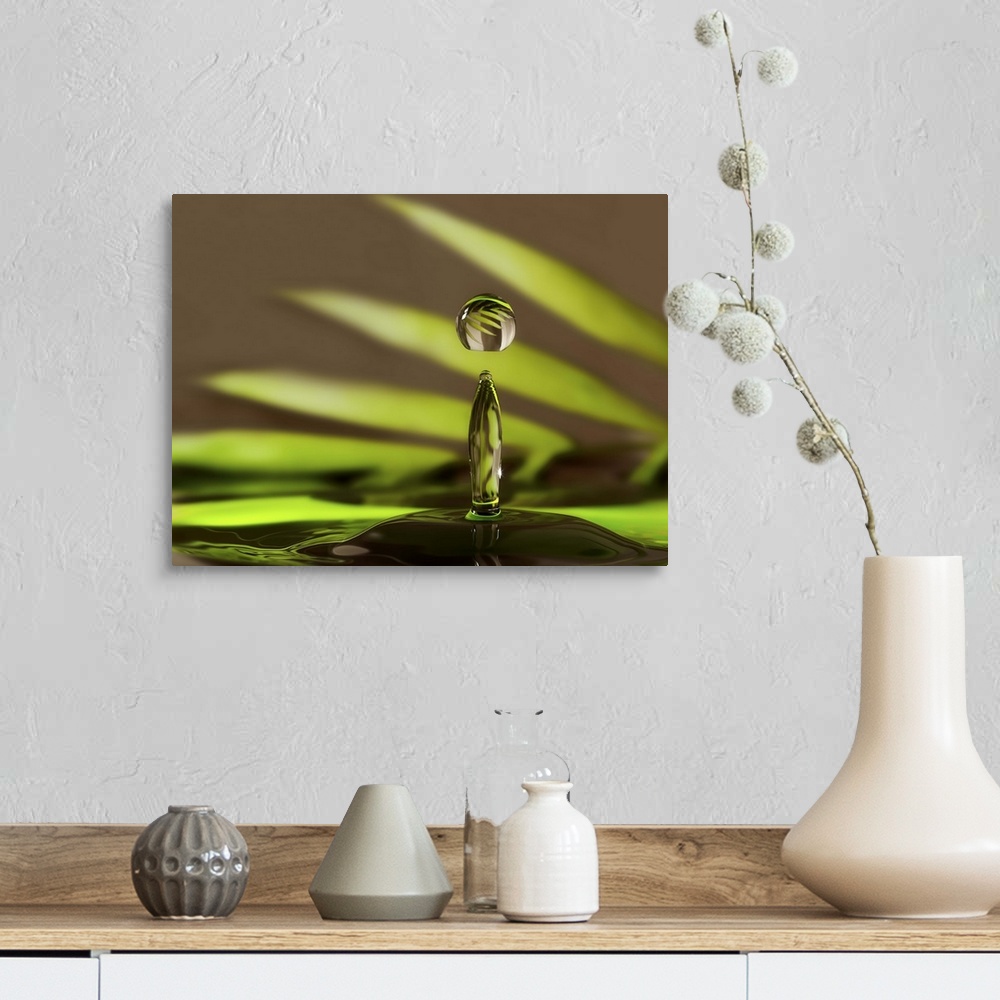 A farmhouse room featuring A macro photograph of a water droplet sitting suspended in air against an abstract background.