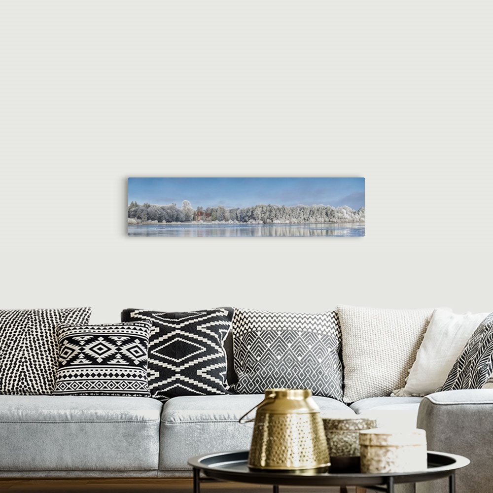 A bohemian room featuring Panoramic photograph of a view across the lake from Broceliande Castle in winter.