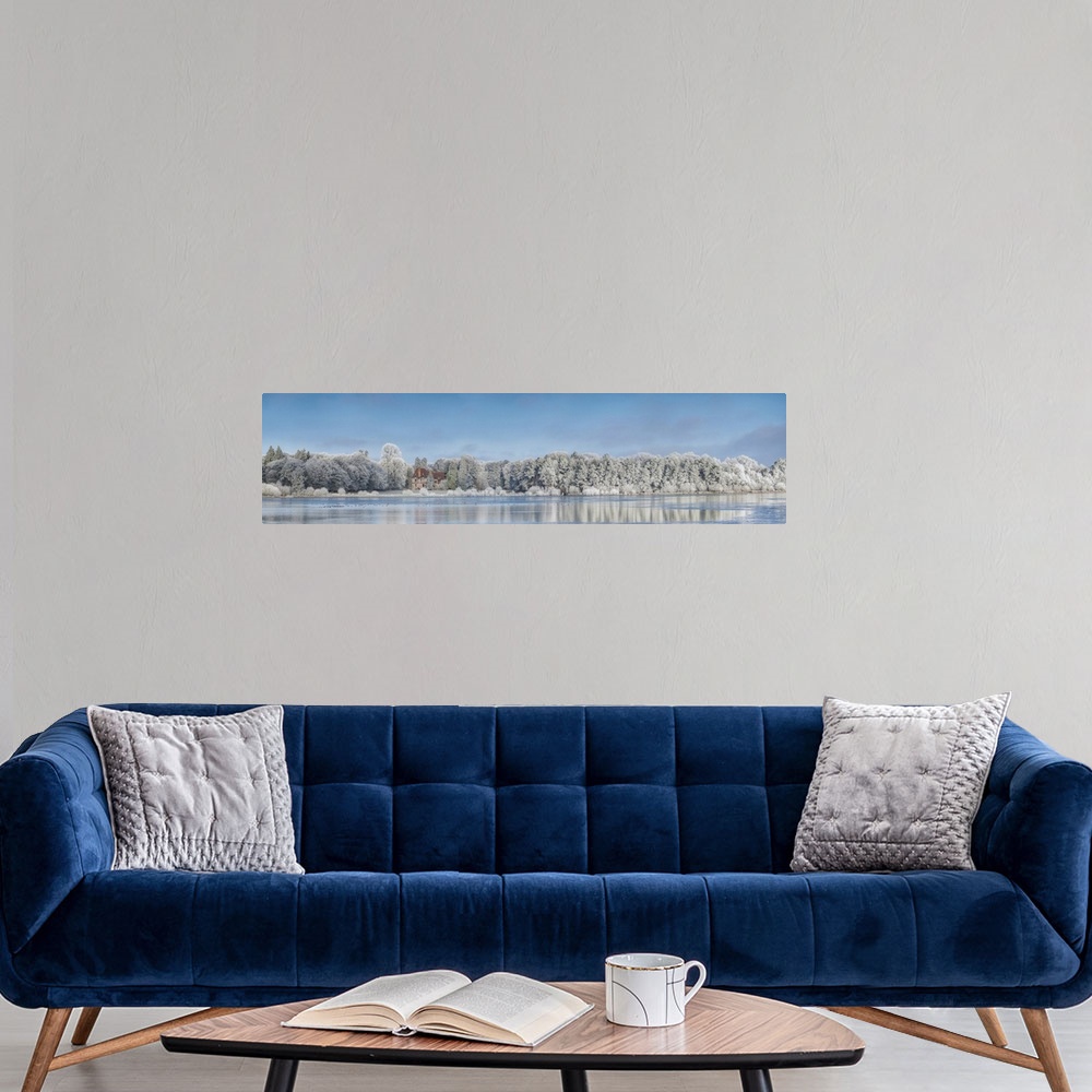 A modern room featuring Panoramic photograph of a view across the lake from Broceliande Castle in winter.