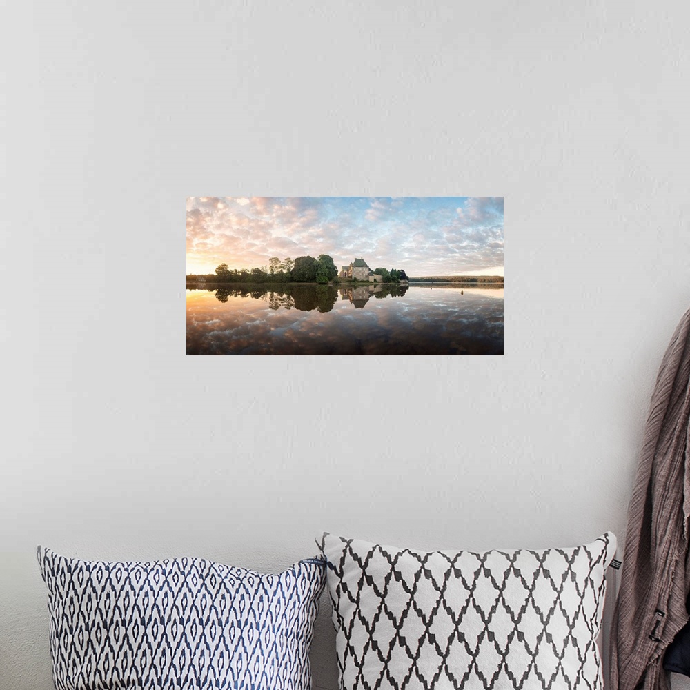 A bohemian room featuring Abbey on the French coast under a pastel sunset sky reflected in the water.