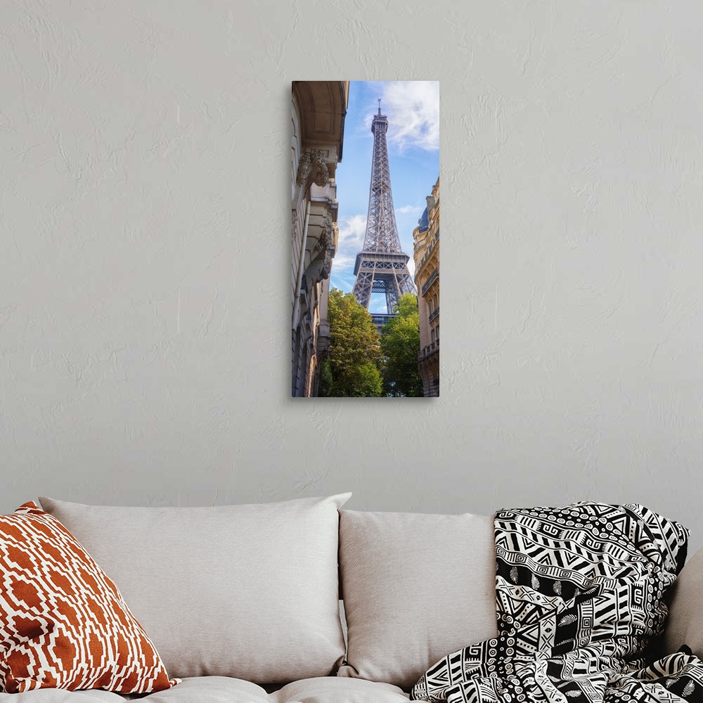 A bohemian room featuring Eiffel tower between typical buildings and trees from the champ de Mars area. Vertical view with ...