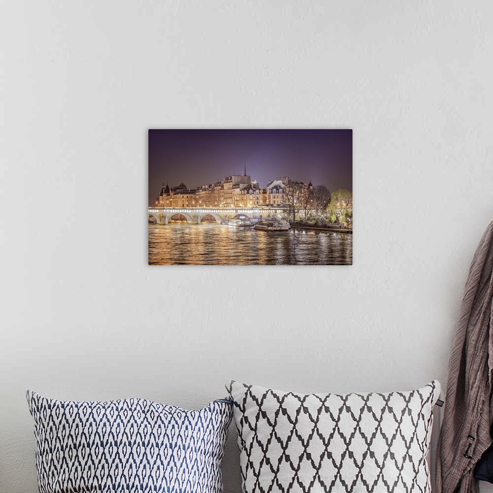 A bohemian room featuring A photograph of Paris from the Seine river at night.