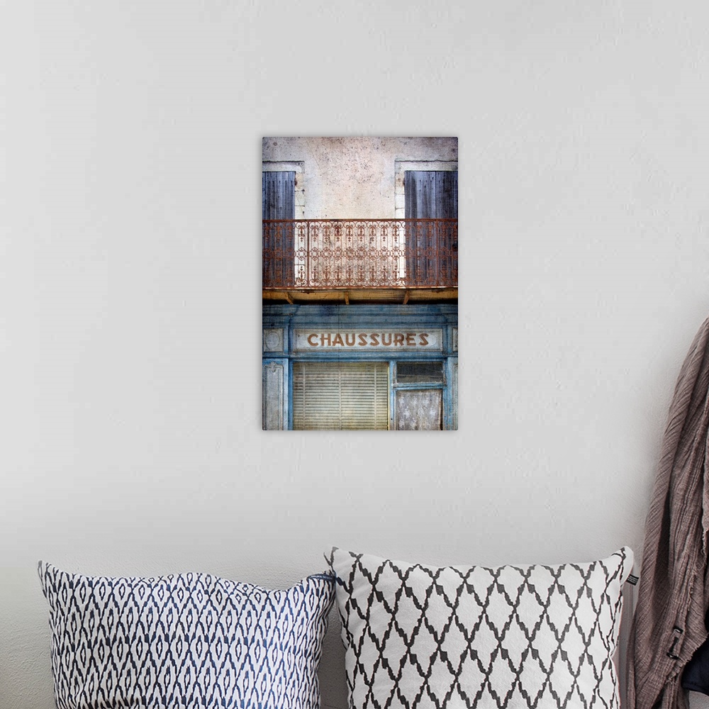 A bohemian room featuring A vintage image of an old faded French shop front in Paris with a wrought iron balcony in blues a...
