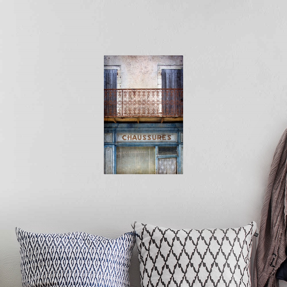 A bohemian room featuring A vintage image of an old faded French shop front in Paris with a wrought iron balcony in blues a...