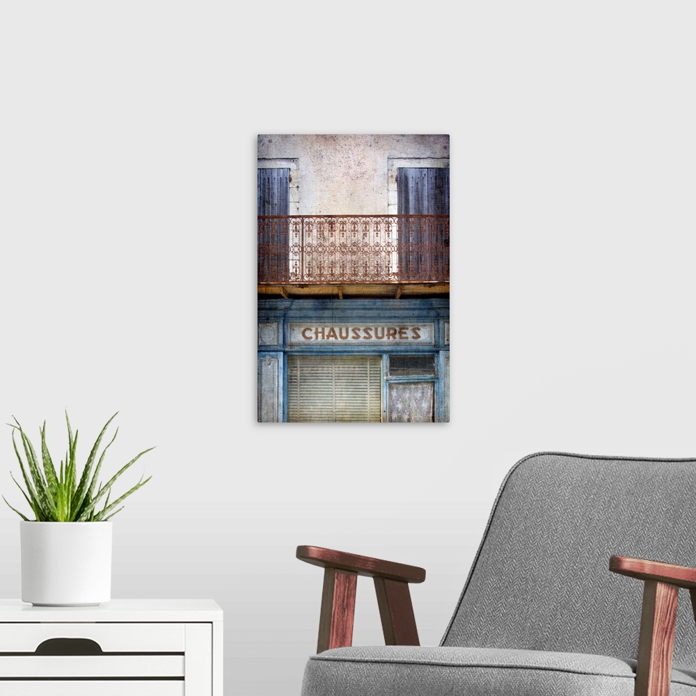 A modern room featuring A vintage image of an old faded French shop front in Paris with a wrought iron balcony in blues a...