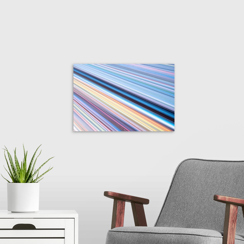 A modern room featuring A contemporary energetic rainbow hued abstract with diagonal lines of many shades of colour.