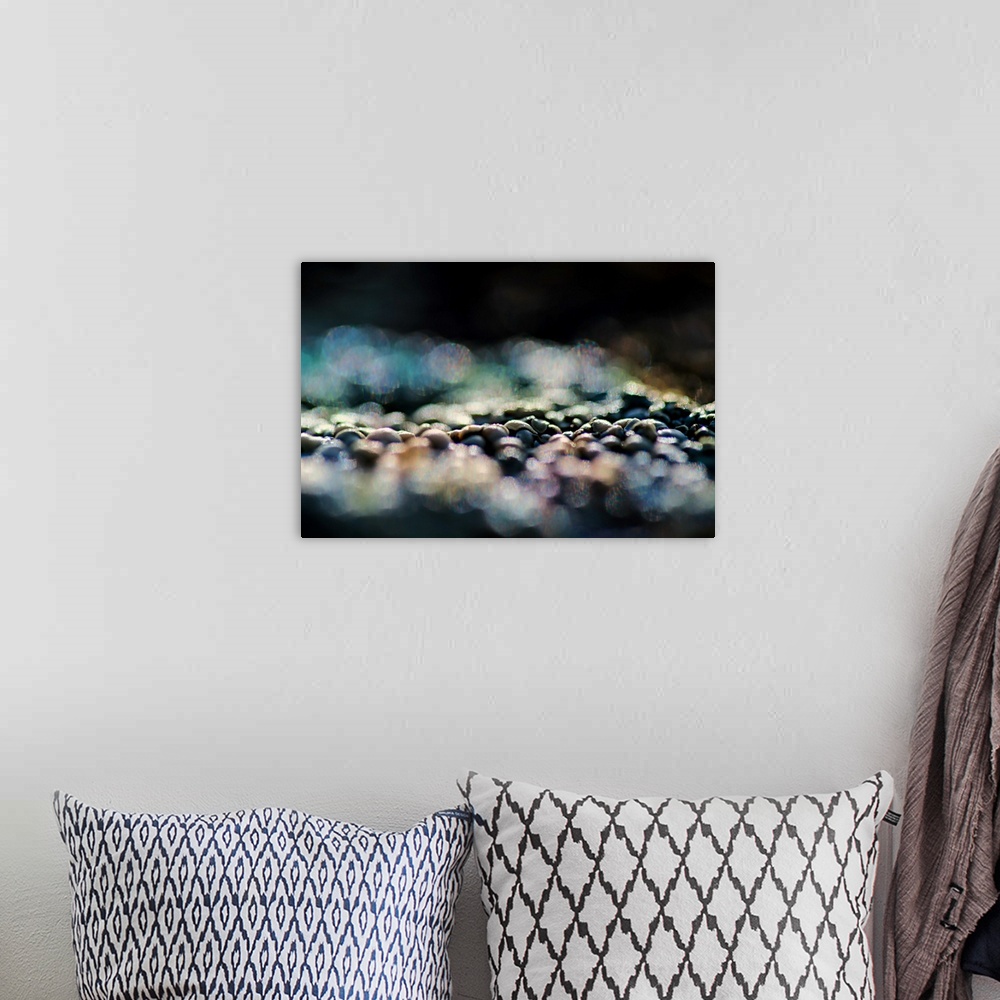 A bohemian room featuring A photo of pebbles that have been blurred in the foreground and background.