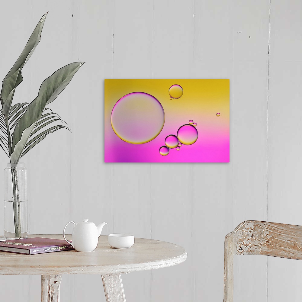 A farmhouse room featuring Closeup photograph of drops of oil in water with yellow and pink hues.