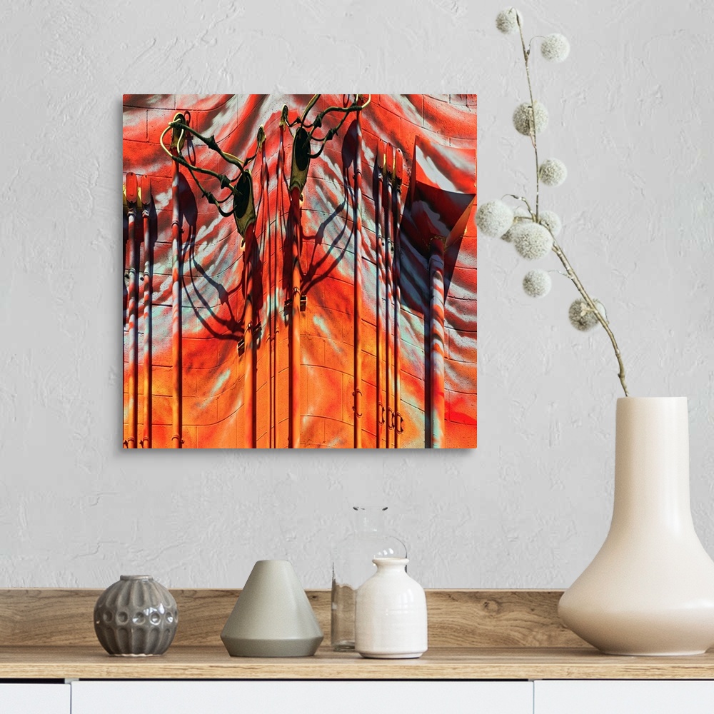 A farmhouse room featuring Conceptual photo of red and orange painted pipes and wires on the side of a building, warped to c...