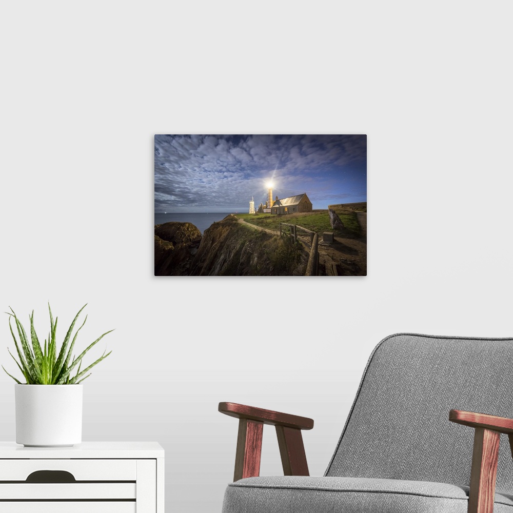 A modern room featuring Night shot of Pointe Saint Mathieu lighthouse under the stars.