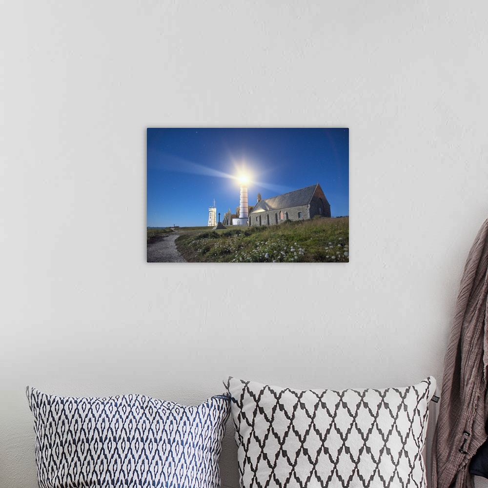 A bohemian room featuring Light shining from the lighthouse on the Bretagne coast in France.