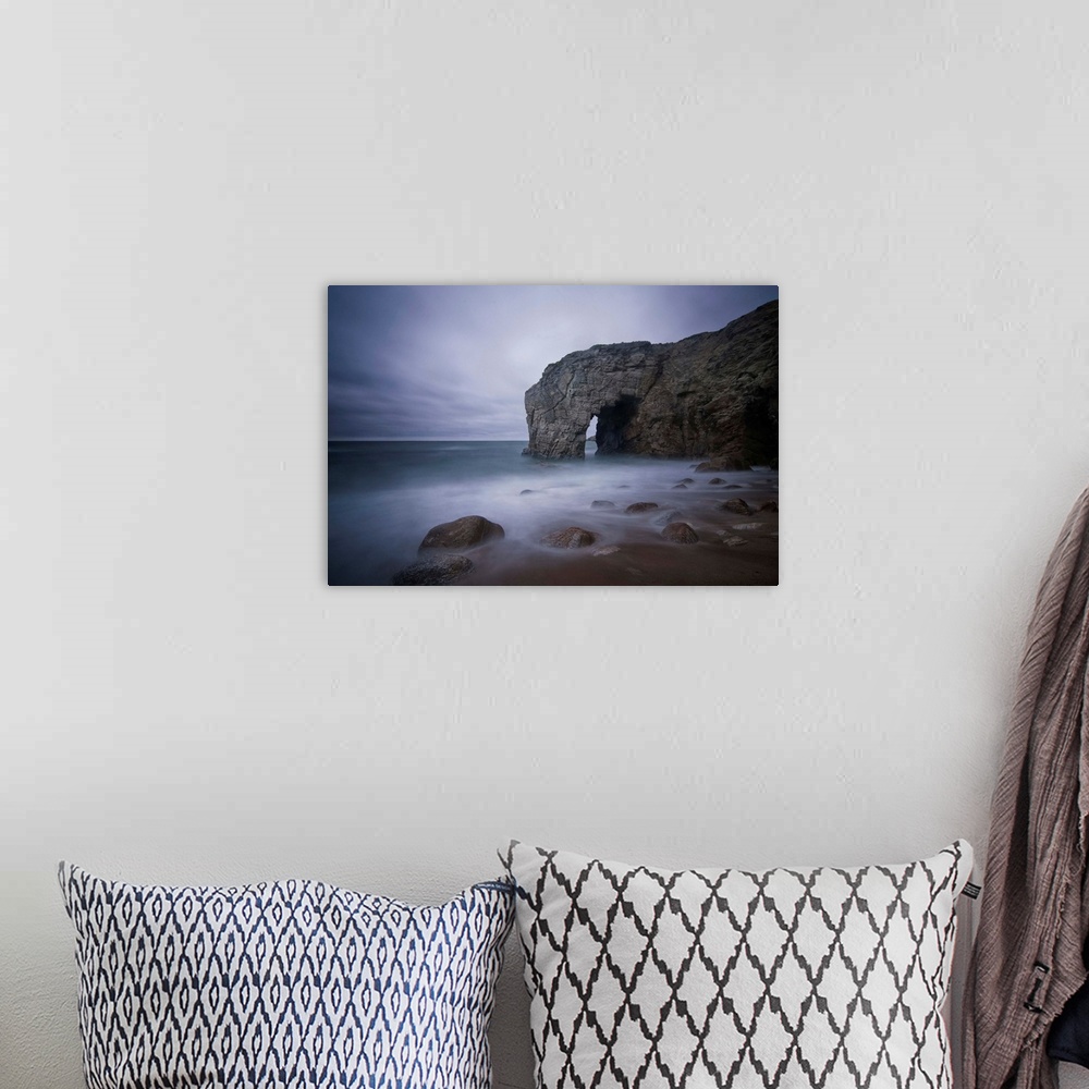 A bohemian room featuring He natural arch rock in Quiberon island in Britany at high tide, a long colored time exposure, sa...