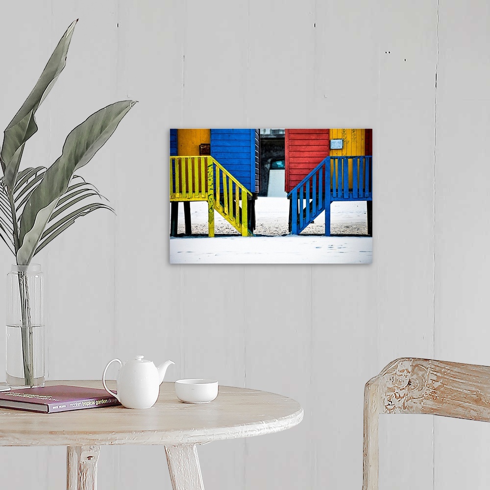 A farmhouse room featuring A photo of colorful buildings that have been painted in primary colors over a white snowy landscape.