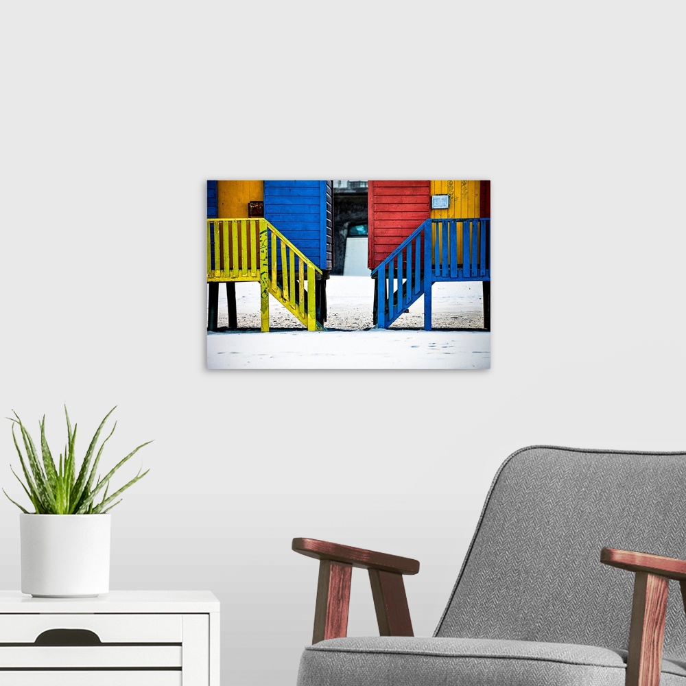 A modern room featuring A photo of colorful buildings that have been painted in primary colors over a white snowy landscape.