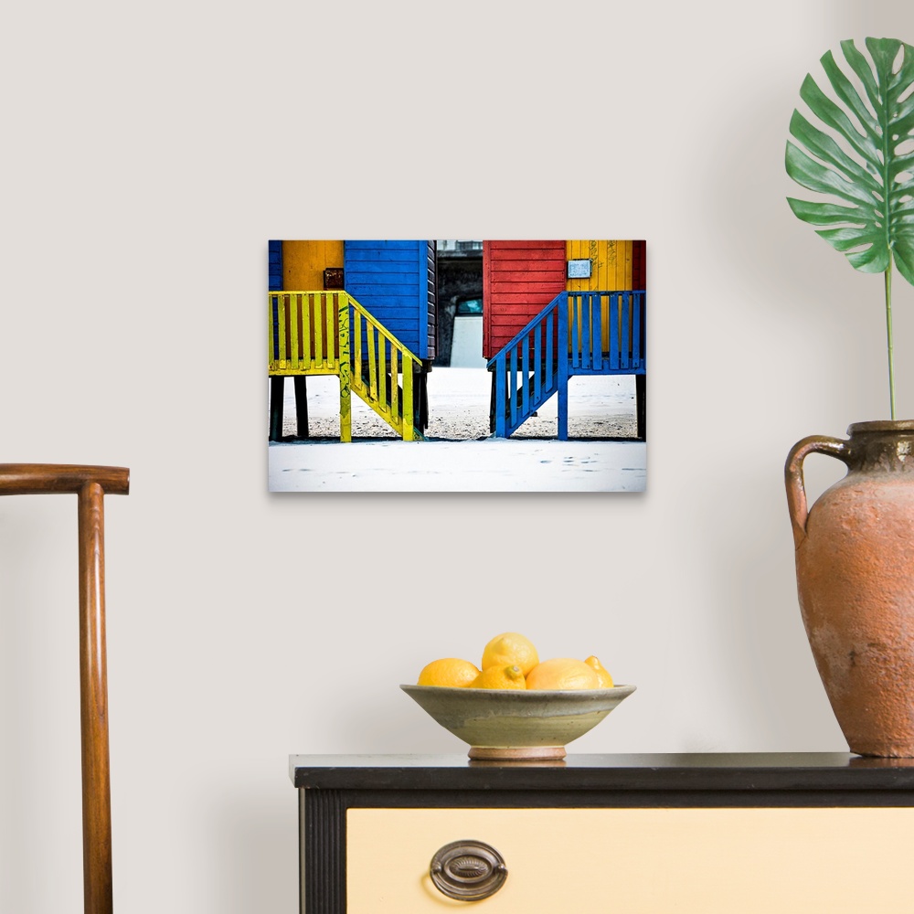 A traditional room featuring A photo of colorful buildings that have been painted in primary colors over a white snowy landscape.