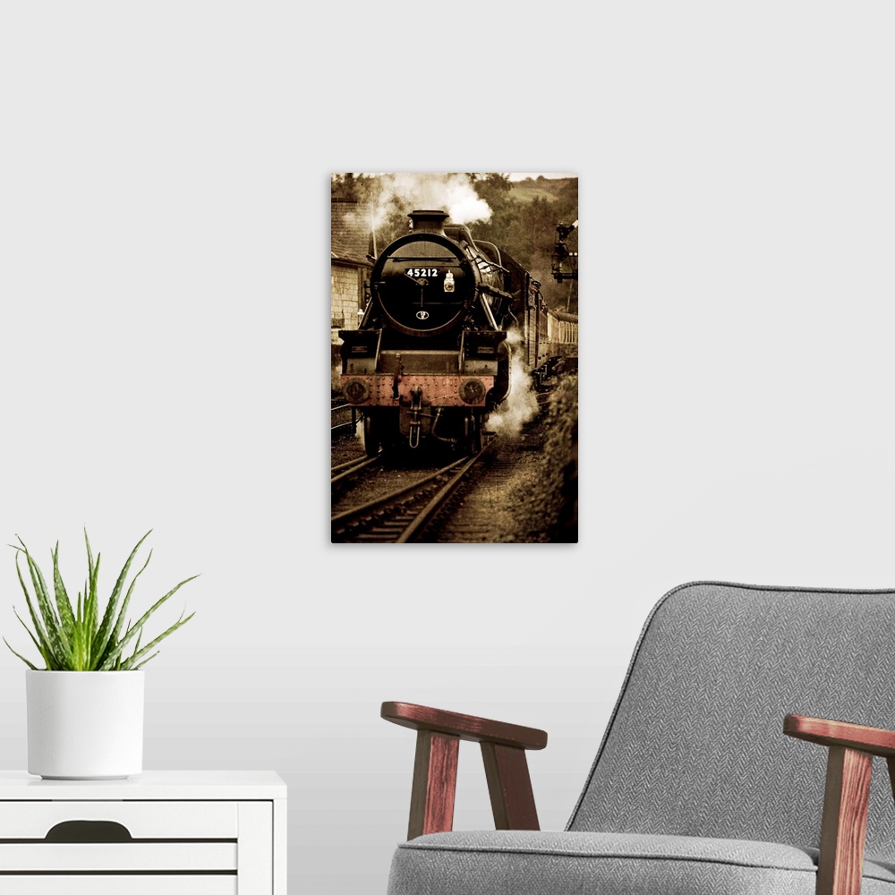 A modern room featuring Photograph of front view of locomotive on tracks blowing smoke and pulling into station, with it'...