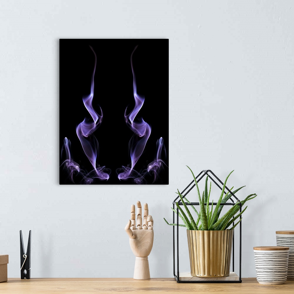 A bohemian room featuring Abstract symmetrical image of purple colored smoke, resembling fire.