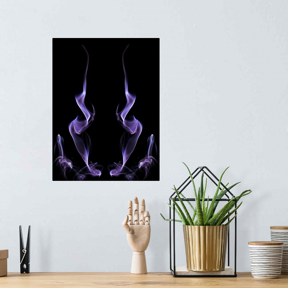 A bohemian room featuring Abstract symmetrical image of purple colored smoke, resembling fire.