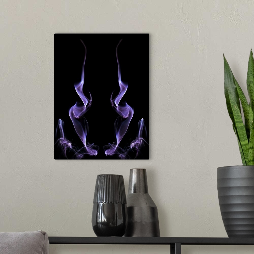 A modern room featuring Abstract symmetrical image of purple colored smoke, resembling fire.