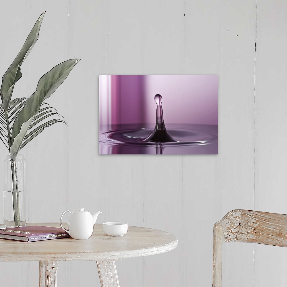 A farmhouse room featuring A macro photograph of a water droplet sitting suspended in air against an abstract background.