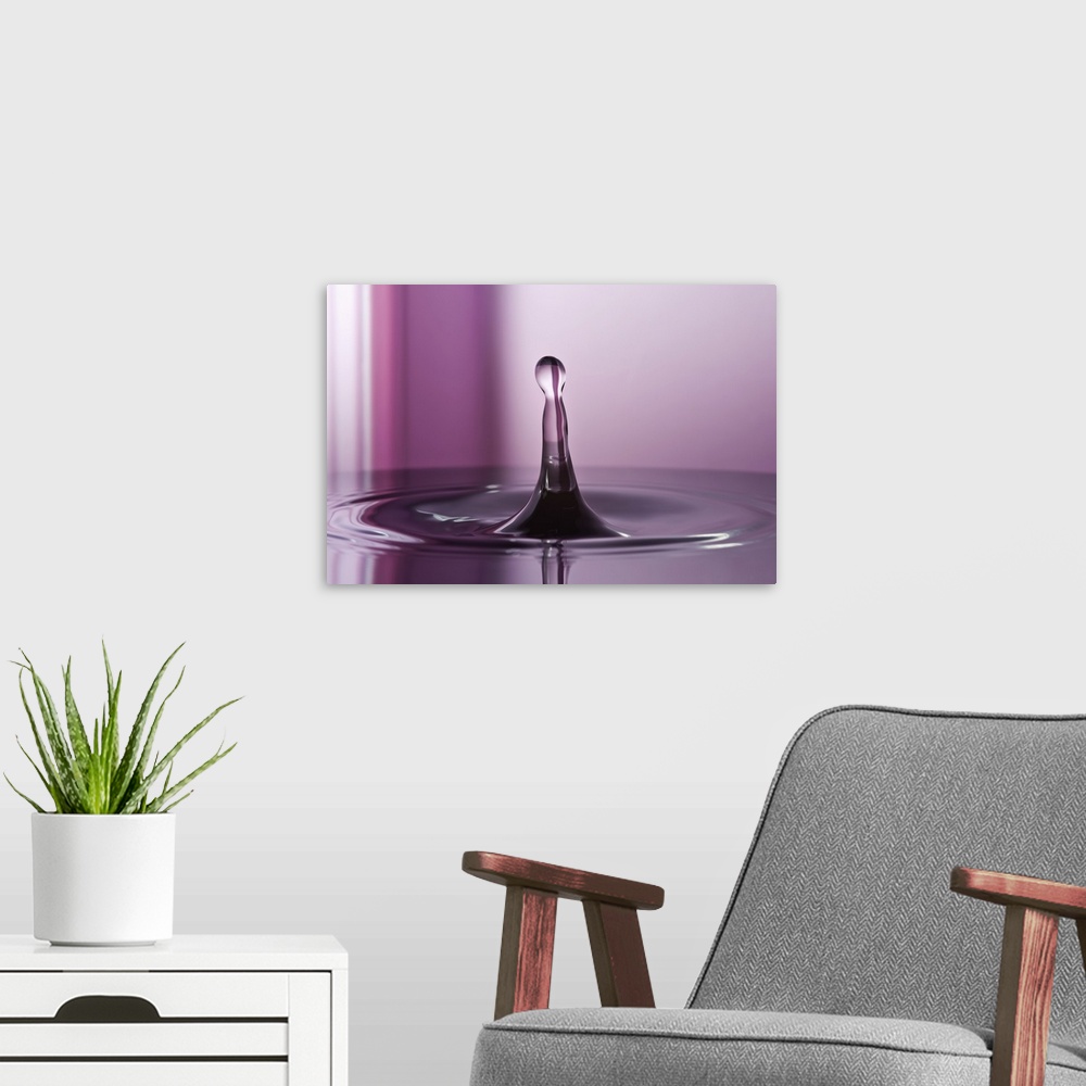 A modern room featuring A macro photograph of a water droplet sitting suspended in air against an abstract background.