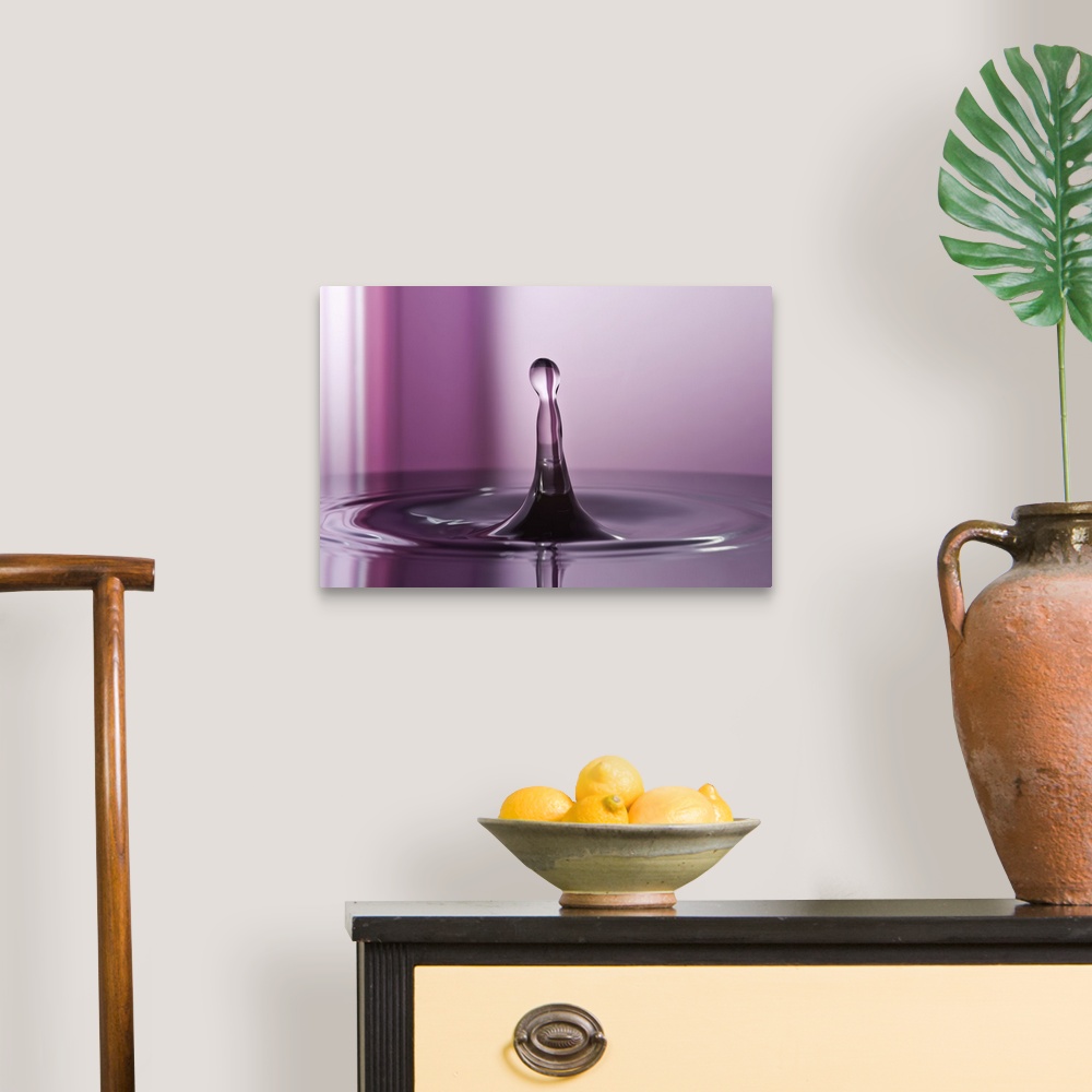 A traditional room featuring A macro photograph of a water droplet sitting suspended in air against an abstract background.