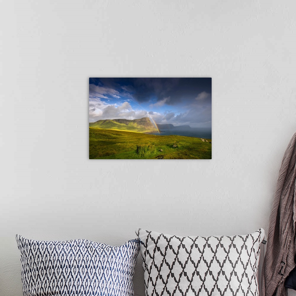 A bohemian room featuring Fine art photo of lush green cliffs at the edge of the sea under a dramatic sky.