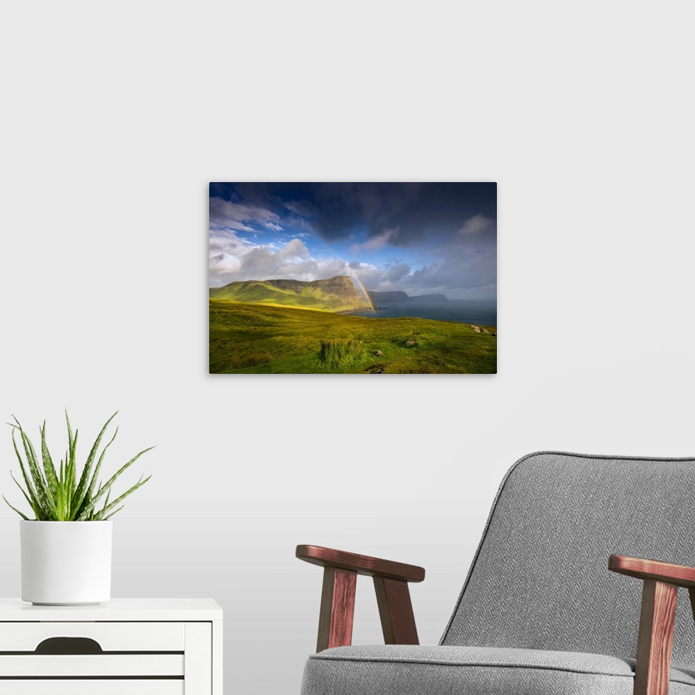 A modern room featuring Fine art photo of lush green cliffs at the edge of the sea under a dramatic sky.