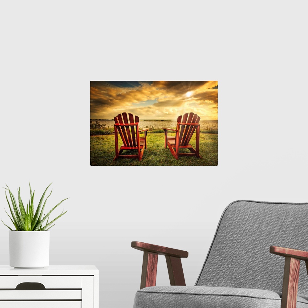 A modern room featuring Two adirondacks in front of a sunset