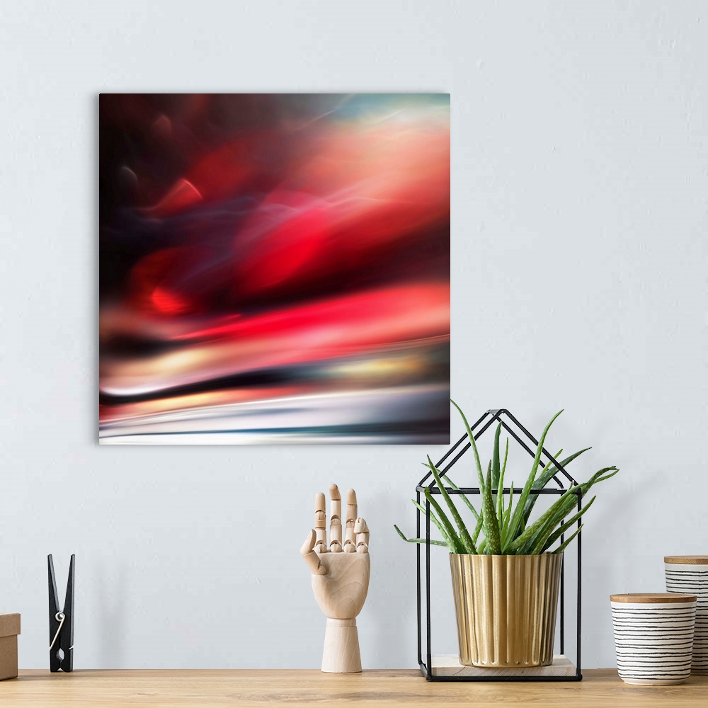 A bohemian room featuring Abstract photograph of a vibrant red motion blurred color field.