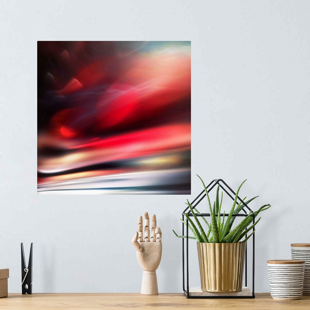 A bohemian room featuring Abstract photograph of a vibrant red motion blurred color field.