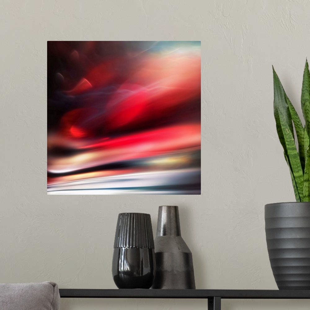 A modern room featuring Abstract photograph of a vibrant red motion blurred color field.