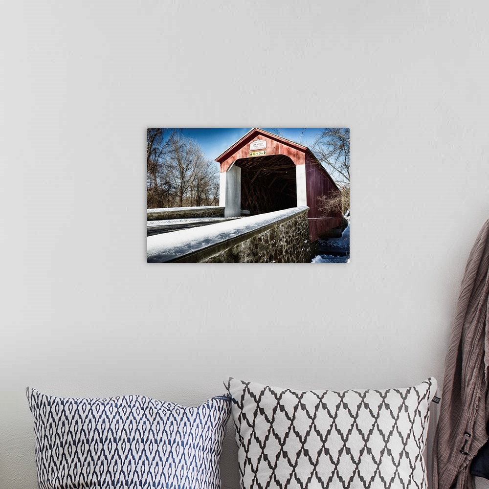 A bohemian room featuring Fine art photo of a covered bridge under a light snowfall.