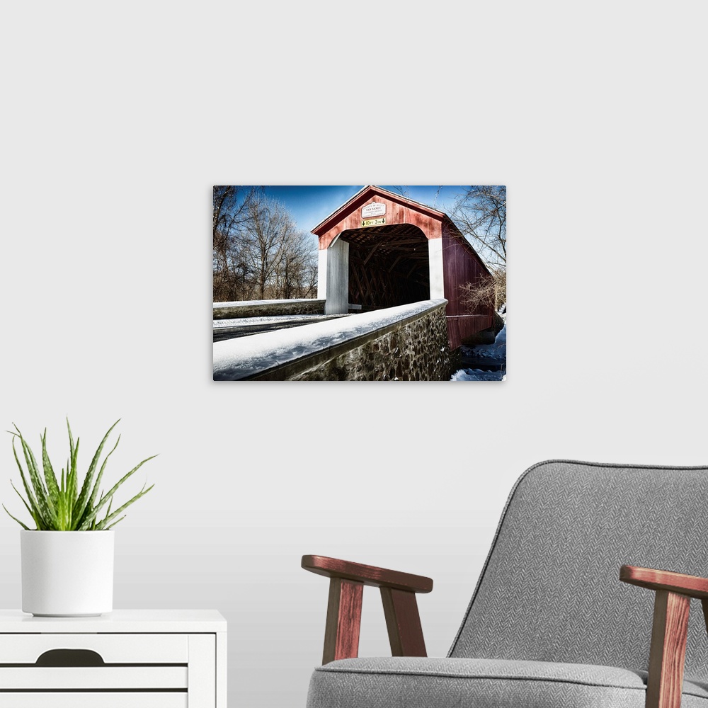 A modern room featuring Fine art photo of a covered bridge under a light snowfall.