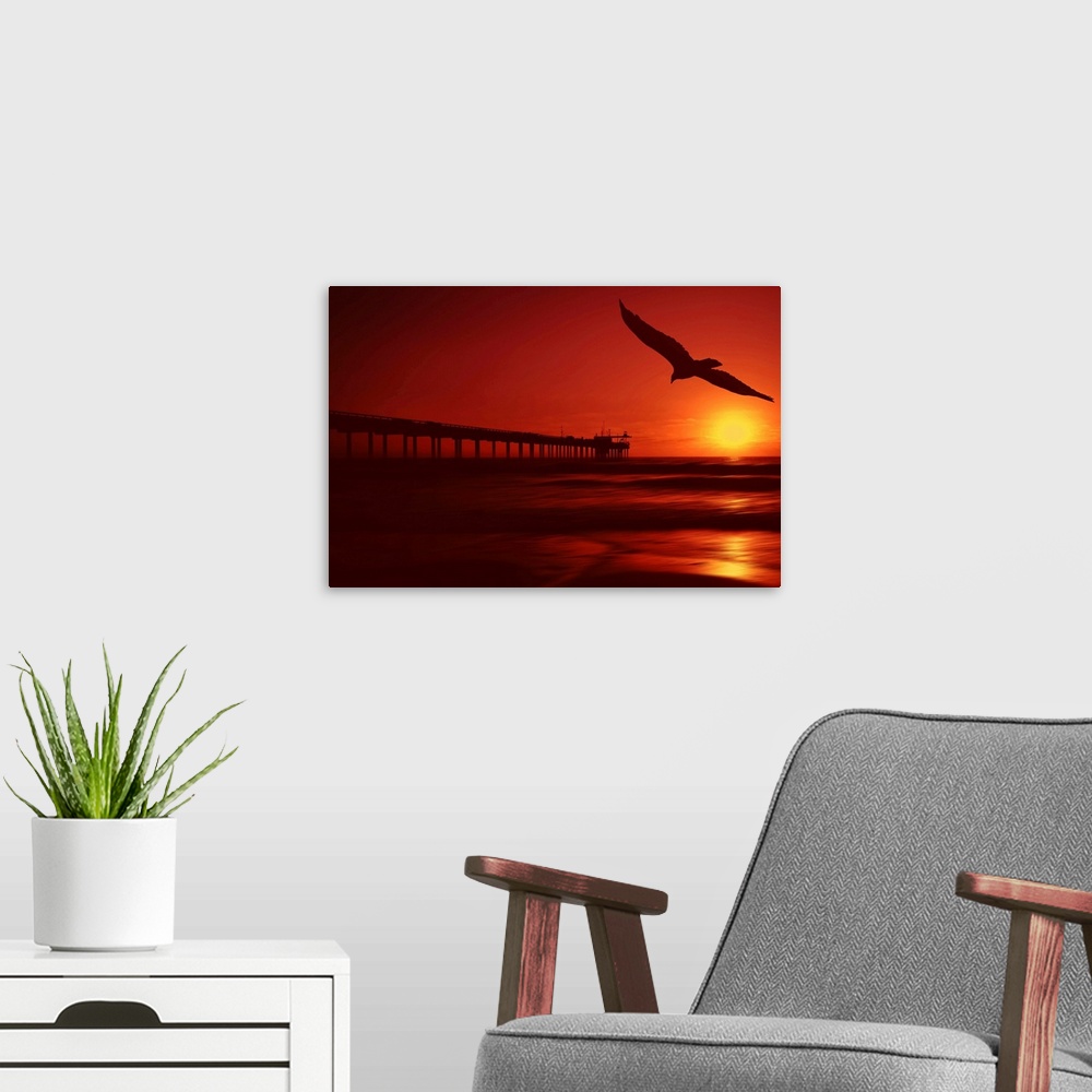 A modern room featuring The sun setting fills this piece with warm tones throughout and a long pier stretches out into th...